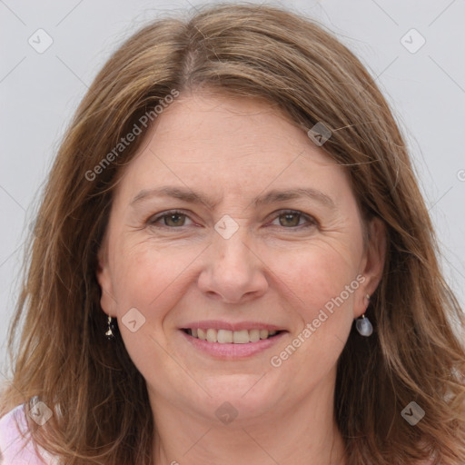 Joyful white adult female with long  brown hair and brown eyes