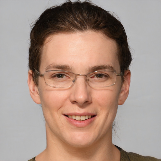 Joyful white adult female with short  brown hair and grey eyes