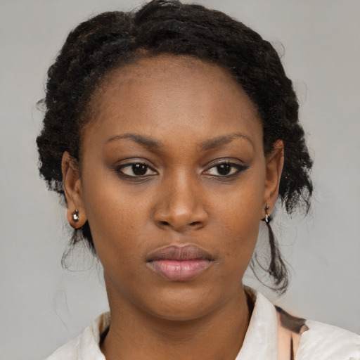 Neutral black young-adult female with medium  brown hair and brown eyes