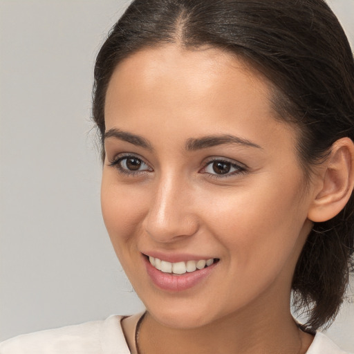 Joyful white young-adult female with medium  brown hair and brown eyes