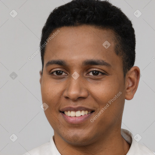 Joyful black young-adult male with short  black hair and brown eyes