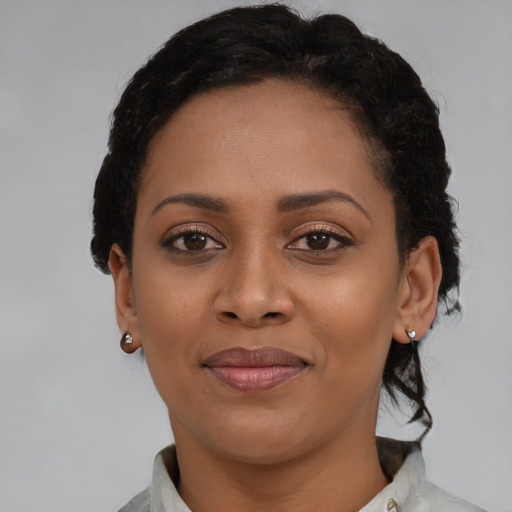 Joyful latino young-adult female with short  black hair and brown eyes