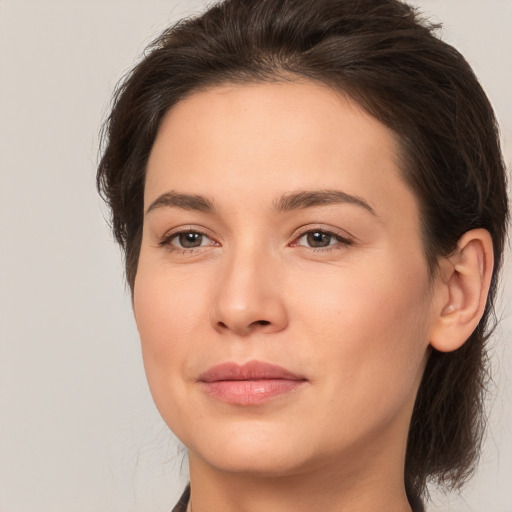 Joyful white young-adult female with medium  brown hair and brown eyes