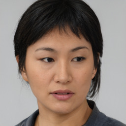 Neutral asian young-adult female with medium  brown hair and brown eyes