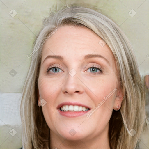 Joyful white adult female with medium  brown hair and blue eyes