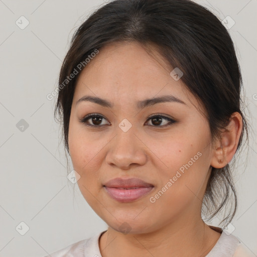 Joyful latino young-adult female with medium  brown hair and brown eyes