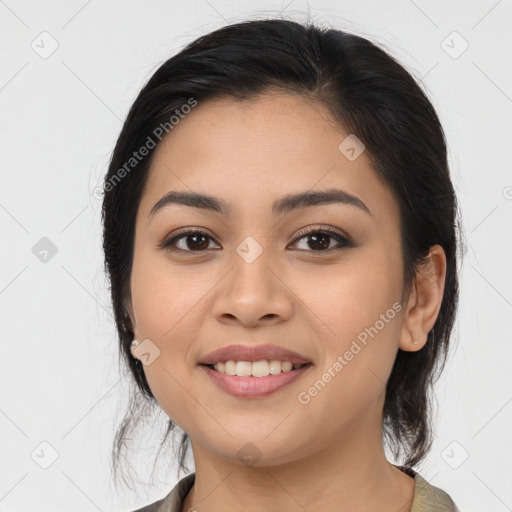 Joyful latino young-adult female with medium  brown hair and brown eyes