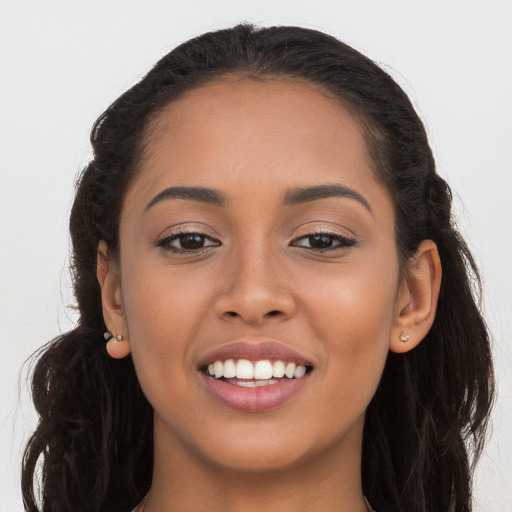 Joyful latino young-adult female with long  brown hair and brown eyes