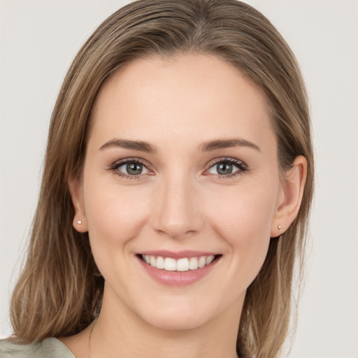 Joyful white young-adult female with medium  brown hair and green eyes