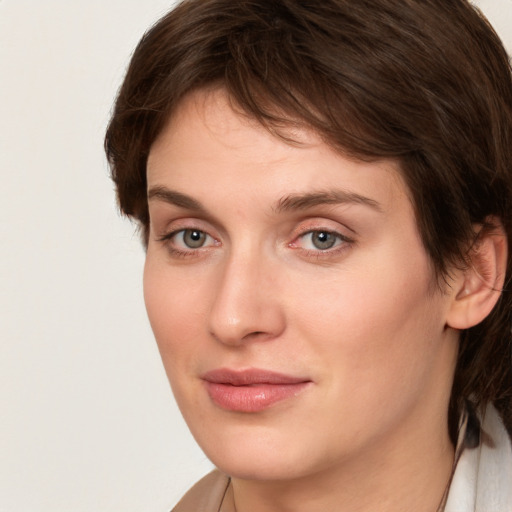 Joyful white young-adult female with medium  brown hair and green eyes