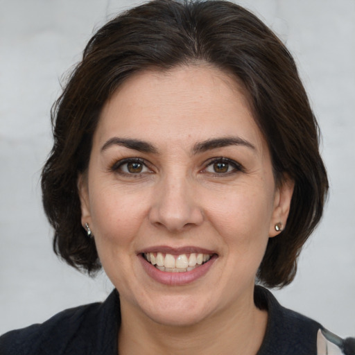 Joyful white adult female with medium  brown hair and brown eyes