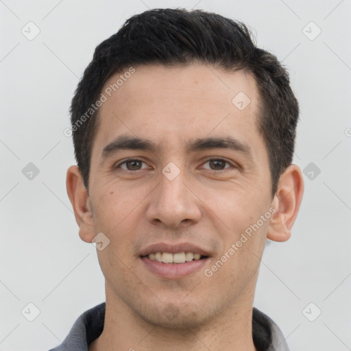 Joyful white young-adult male with short  black hair and brown eyes