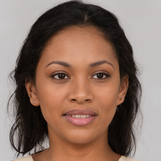 Joyful latino young-adult female with medium  brown hair and brown eyes