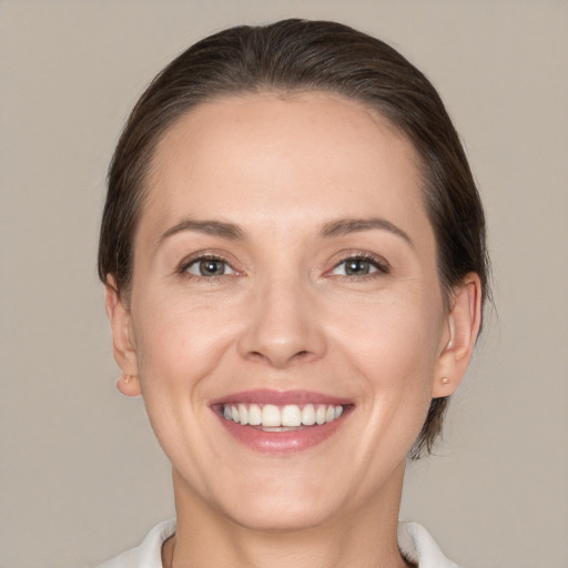 Joyful white young-adult female with medium  brown hair and brown eyes