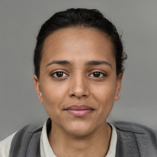 Joyful white young-adult female with short  black hair and brown eyes