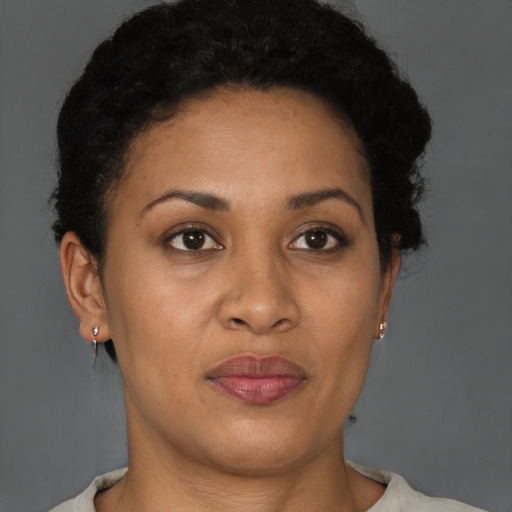 Joyful black adult female with short  brown hair and brown eyes