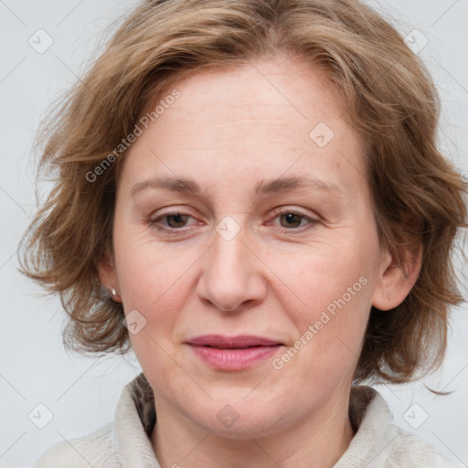 Joyful white adult female with medium  brown hair and blue eyes