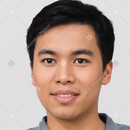 Joyful asian young-adult male with short  black hair and brown eyes