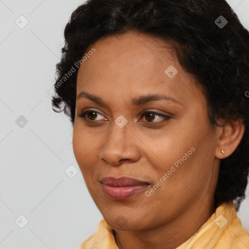 Joyful black adult female with short  brown hair and brown eyes