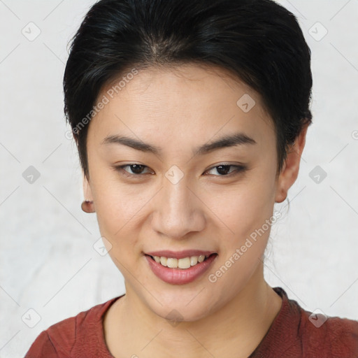 Joyful asian young-adult female with short  brown hair and brown eyes