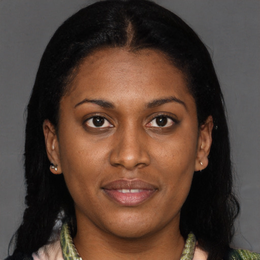 Joyful black young-adult female with short  brown hair and brown eyes