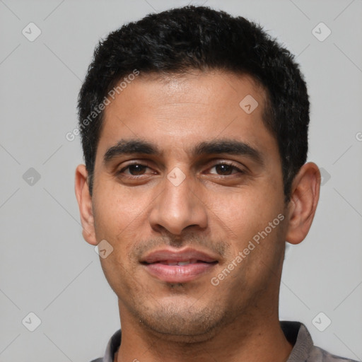 Joyful latino young-adult male with short  black hair and brown eyes