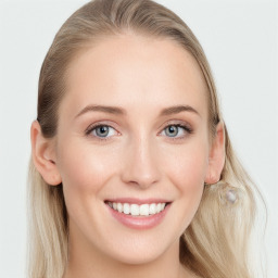 Joyful white young-adult female with long  brown hair and blue eyes