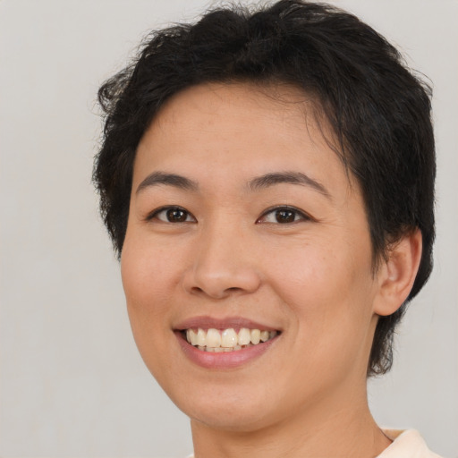 Joyful asian young-adult female with short  brown hair and brown eyes