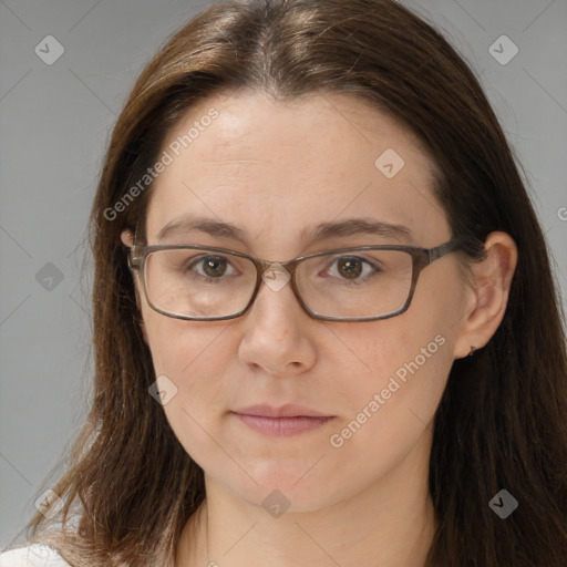 Joyful white adult female with long  brown hair and brown eyes