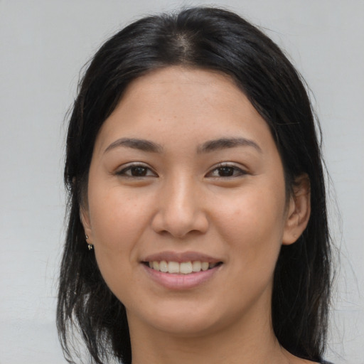 Joyful asian young-adult female with long  brown hair and brown eyes