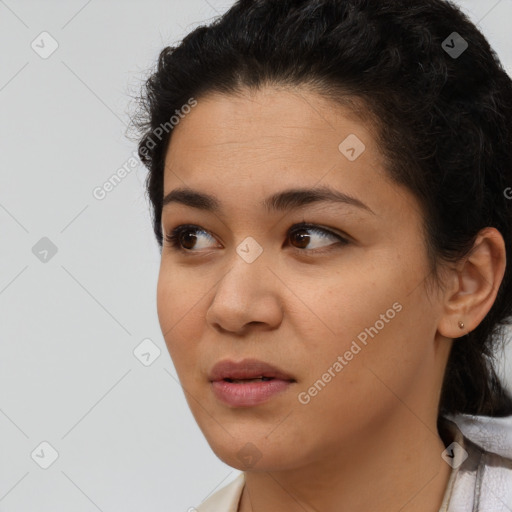 Joyful latino young-adult female with short  black hair and brown eyes