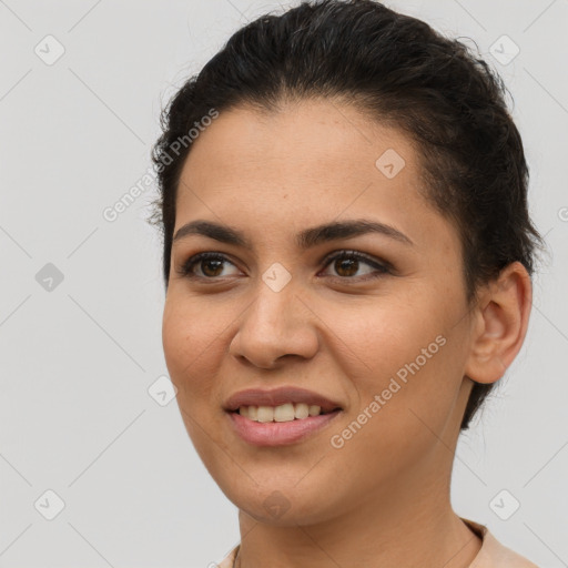 Joyful latino young-adult female with short  brown hair and brown eyes