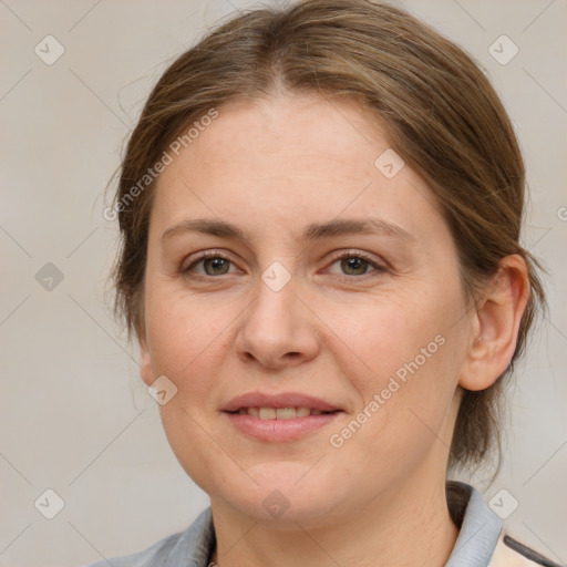 Joyful white adult female with medium  brown hair and grey eyes