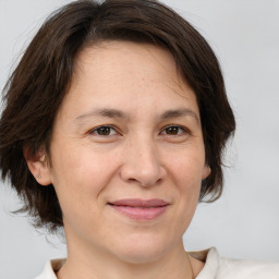 Joyful white adult female with medium  brown hair and brown eyes