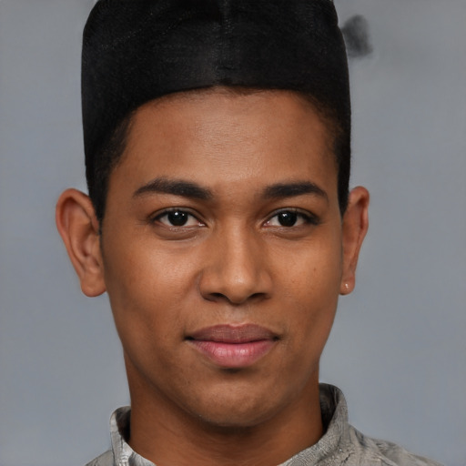 Joyful latino young-adult male with short  brown hair and brown eyes