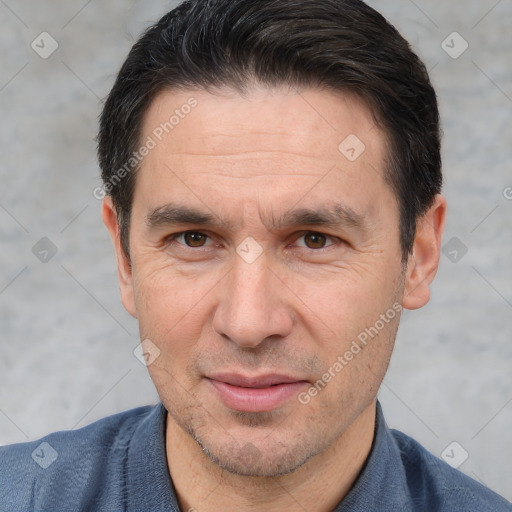 Joyful white adult male with short  brown hair and brown eyes