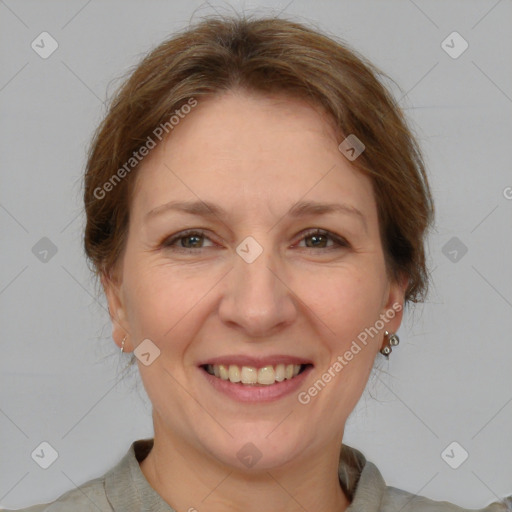 Joyful white adult female with medium  brown hair and grey eyes