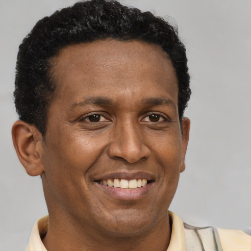 Joyful latino adult male with short  brown hair and brown eyes
