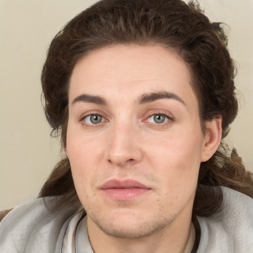 Joyful white young-adult male with short  brown hair and green eyes