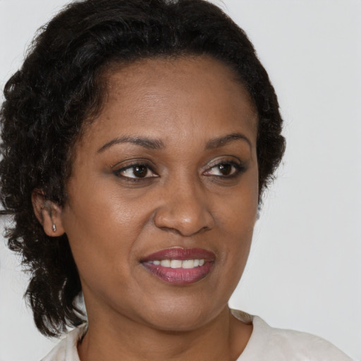 Joyful black adult female with short  brown hair and brown eyes