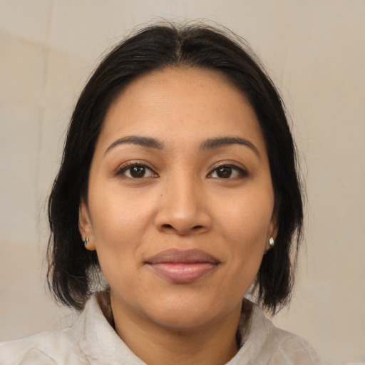 Joyful latino young-adult female with medium  brown hair and brown eyes