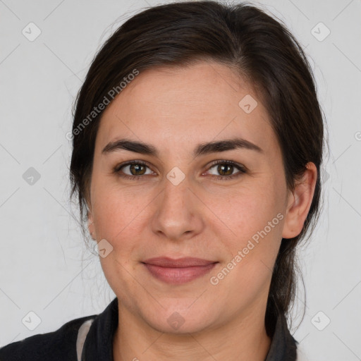 Joyful white adult female with medium  brown hair and brown eyes