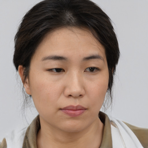 Neutral asian young-adult female with medium  brown hair and brown eyes