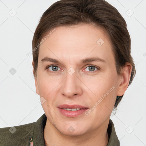 Joyful white adult female with short  brown hair and grey eyes