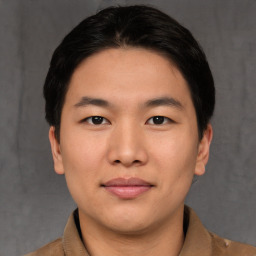 Joyful asian young-adult male with short  brown hair and brown eyes