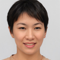 Joyful asian young-adult female with short  brown hair and brown eyes