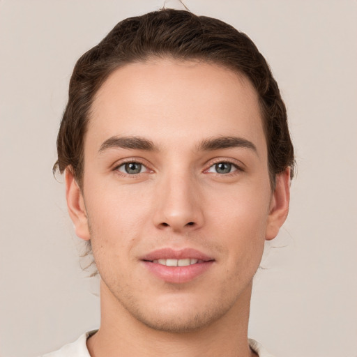 Joyful white young-adult male with short  brown hair and grey eyes