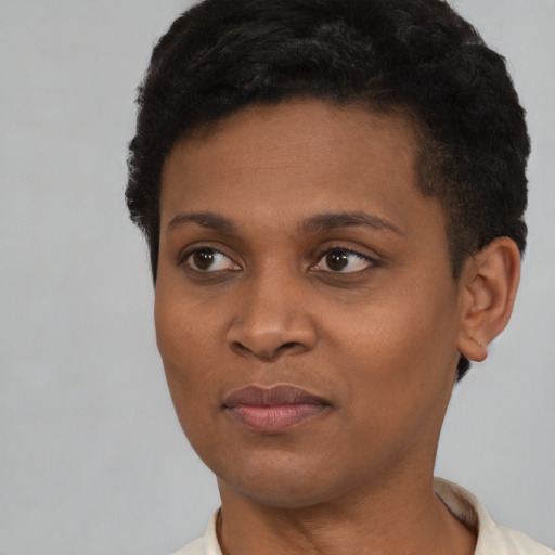 Joyful black young-adult female with short  brown hair and brown eyes