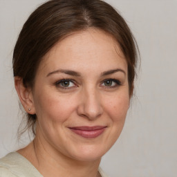 Joyful white adult female with medium  brown hair and brown eyes