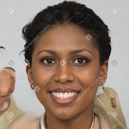 Joyful black young-adult female with short  brown hair and brown eyes